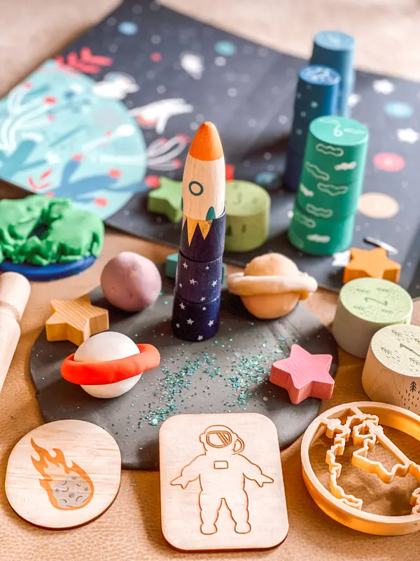 A space-themed playdough kit with rockets and planets